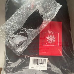 Men in black unisex costume. Jacket has pockets and the pants. Free glasses